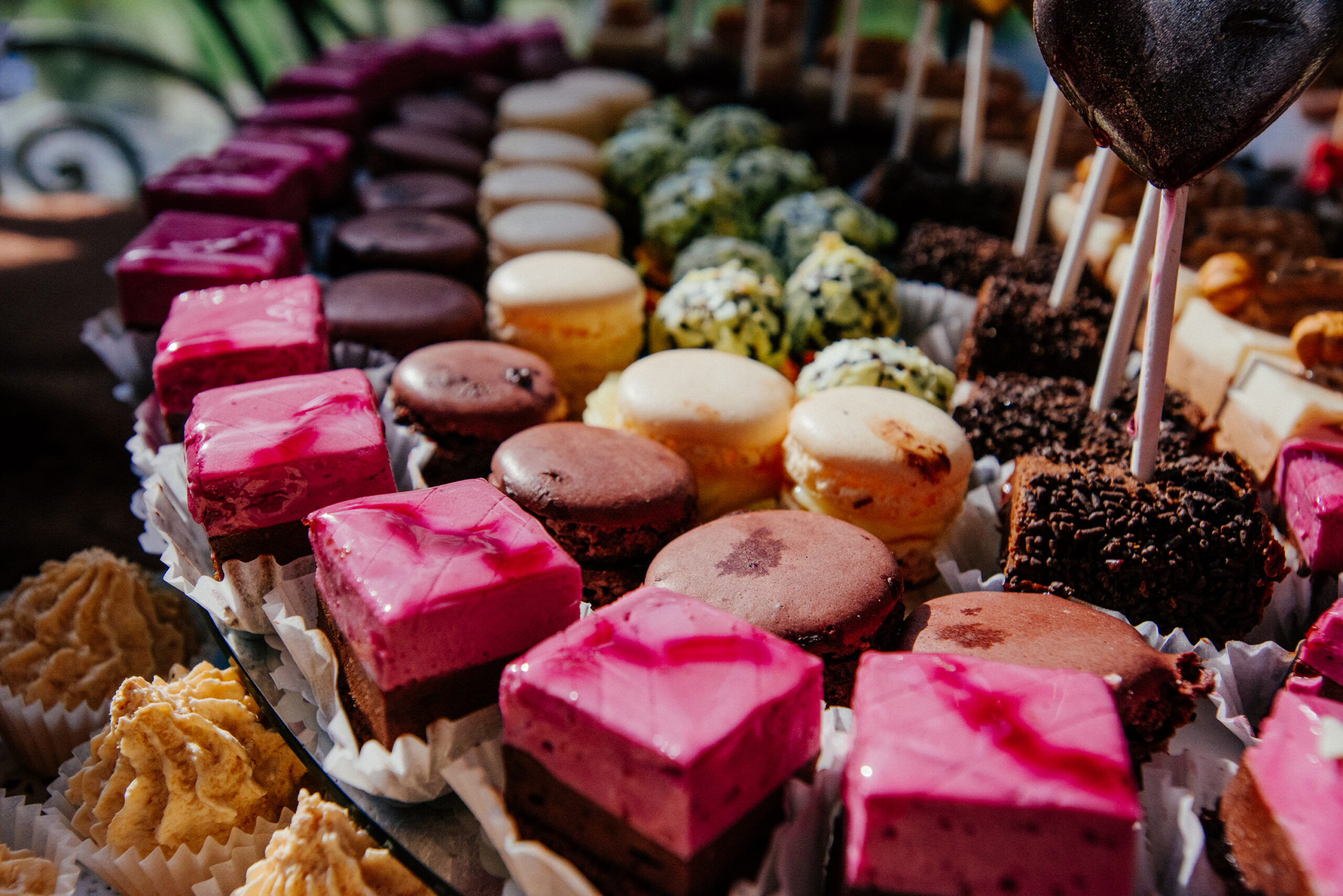 Catering at a luxury event with a wide choice of delicious gourmet desserts displayed on a long buffet table